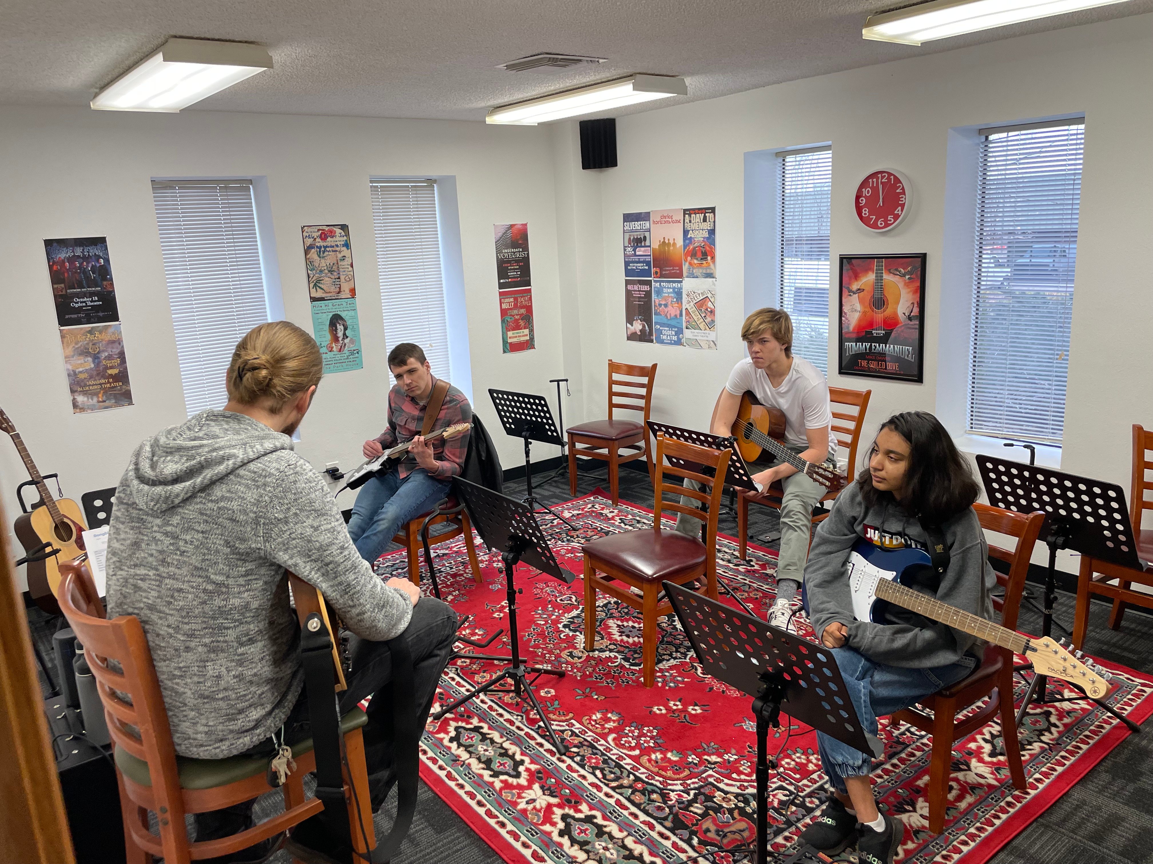 A class with teenagers taking guitar lessons