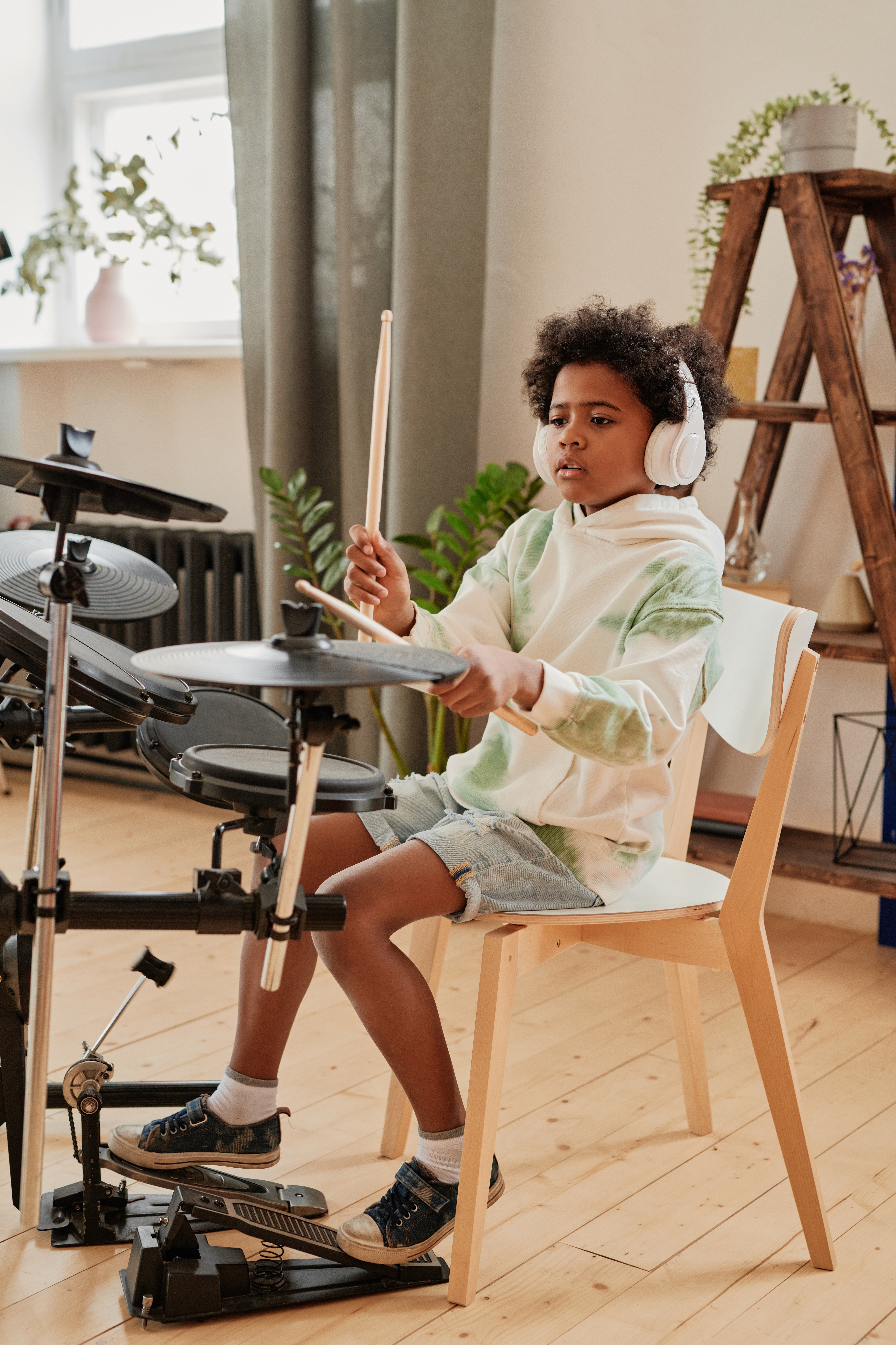 A young man taking a drum lesson on electric drums